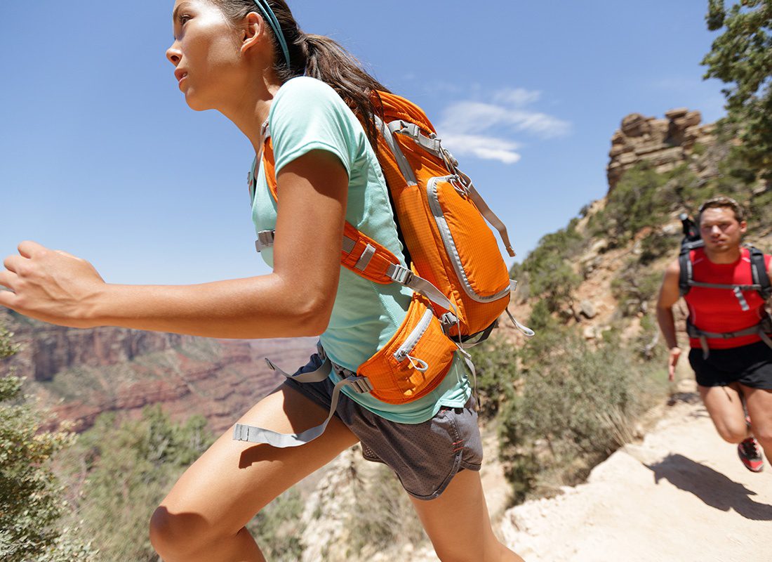Employee Benefits - Trail Runner Cross Country Running Grand Canyon on a Sunny Day