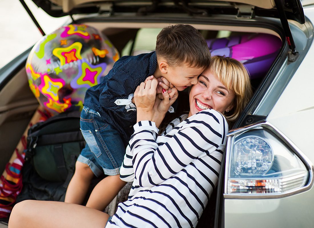 Personal Insurance - Mother With a Child in the Car Going to Have a Road Trip